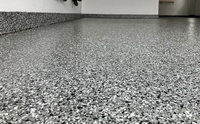 Image of black, gray & white flake flooring in a residential garage