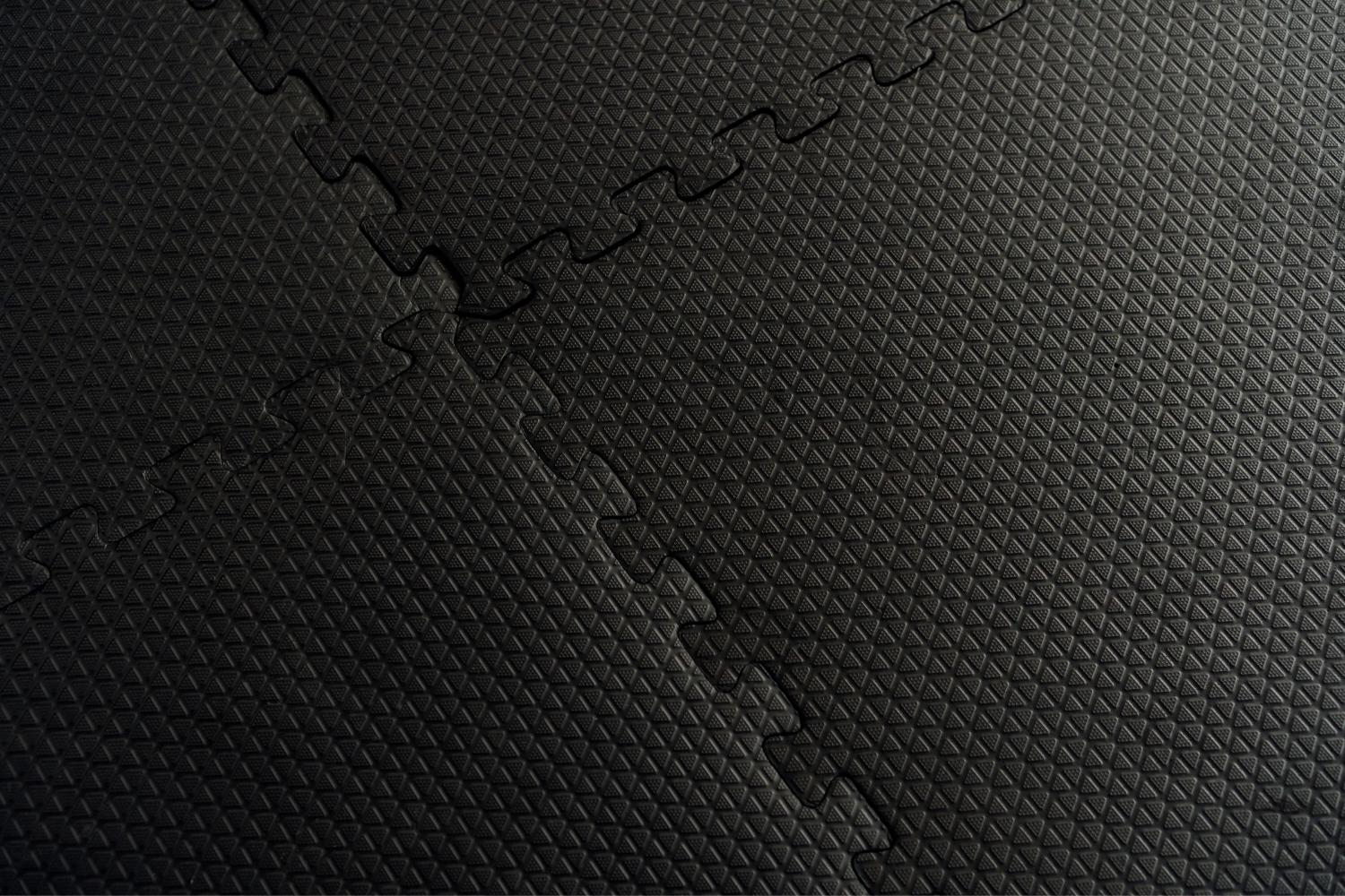 A closeup image of interlocking rubber floor tiles